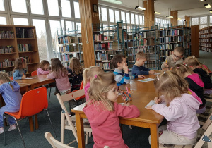 Zajęcia w bibliotece - dzieci wykonują rysunek do opowiadania.