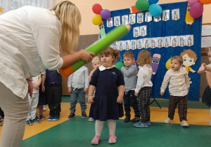 Nauczycielka pasuje dziewczynkę kredką