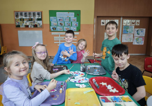 Dzieci malują farbami drewniane ozdoby