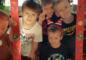 Dzieci pozują w świątecznej fotobudce.