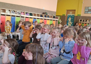 Uśmiechnięte dzieci siedzące na ławeczkach