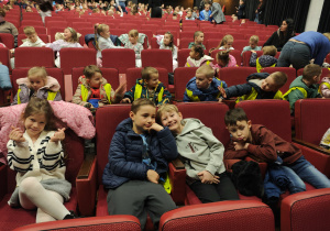 Dzieci siedzące na fotelach w teatrze