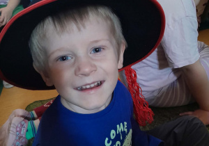 Chłopiec ma na głowie założony kapelusz