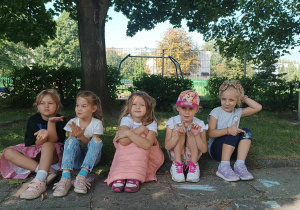 Dziewczynki pozują do zdjęcia w ogrodzie przedszkolnym