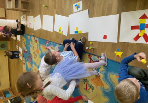 dzieci bawiące się kolorowymi figurami geometrycznymi