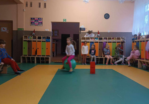 Dziewczynka skacze na piłce w holu przedszkolnym