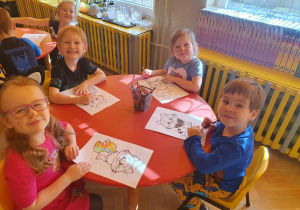 Dzień Kota - dzieci siedzą przy stolikach i kolorują koty