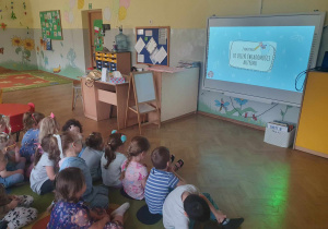 Dzień Świadomości Autyzmu - dzieci oglądają prezentację multimedialną o dzieciach autystycznych